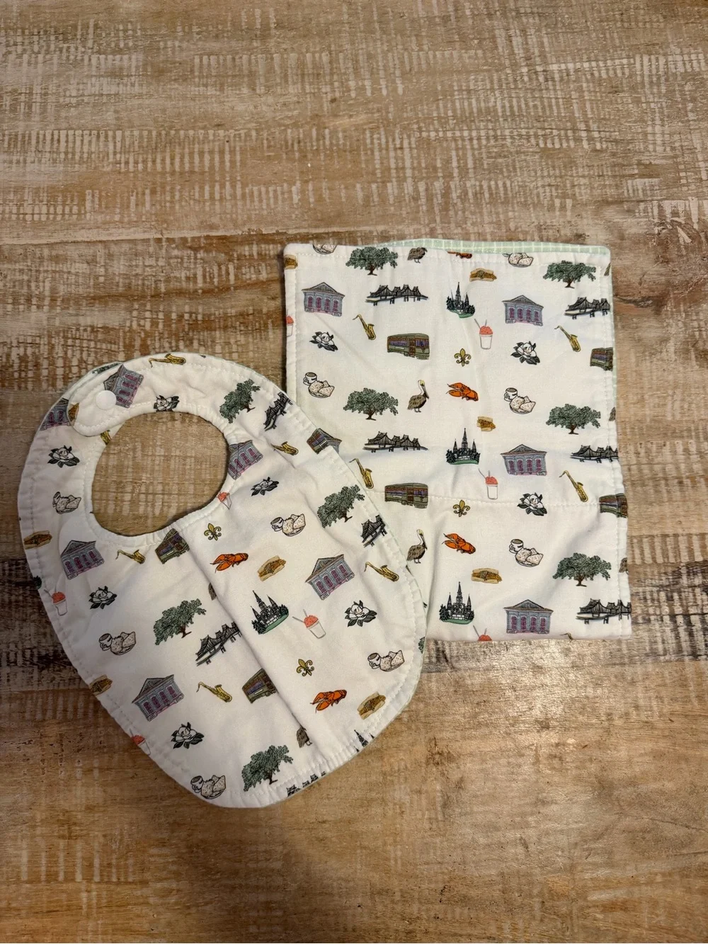 Gender neutral New Orleans reversible bib and burp set. NWOT